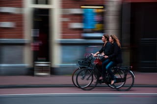 Cyclists riding through city with motion blur