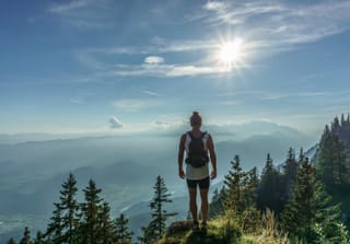 Hiker standing on mountain summit