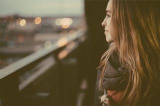Woman looking out train window