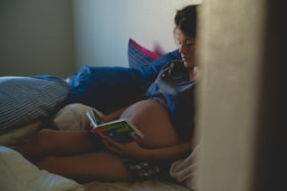 Woman reading book in bed