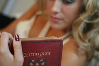 Woman reading tennyson book close-up