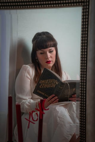 Woman reading a book in a vintage-inspired indoor portrait.