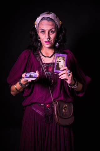 Woman wearing a burgundy vintage costume in a studio portrait.