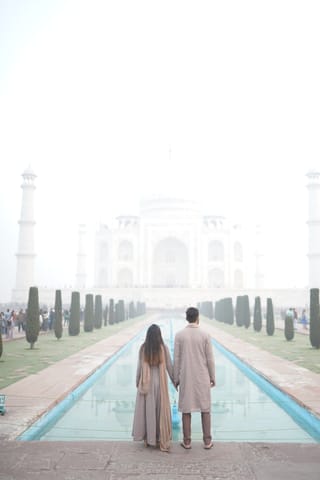 Couple walking toward the Taj Mahal in Agra, India.