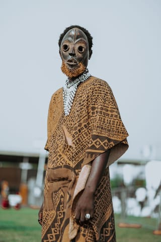 Person wearing a traditional mask and cultural costume.