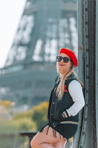 Woman in winter fashion posing near the Eiffel Tower in Paris.