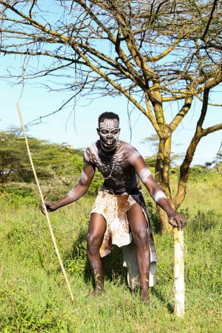 Man traditional warrior outfit spear outdoors