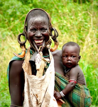 Woman holding baby traditional jewelry portrait