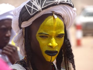 Woman yellow face paint headwrap cultural portrait
