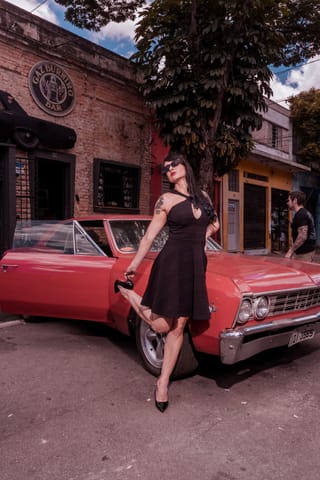 Woman black dress red classic car