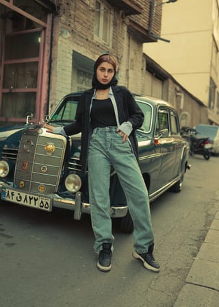 Woman black outfit vintage car street portrait