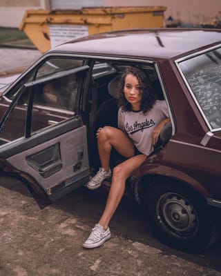 Woman sitting open car door vintage portrait