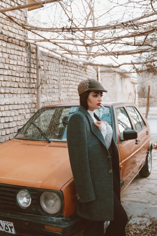 Woman winter coat vintage car portrait