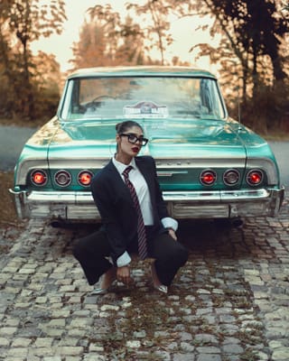 Businesswoman suit classic car portrait