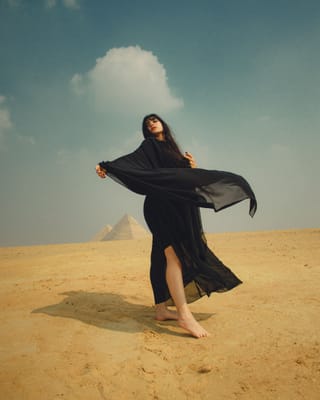 Woman black dress desert pyramid travel portrait