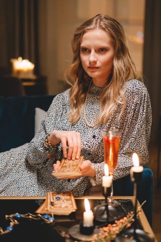 Woman candlelit table moody indoor portrait