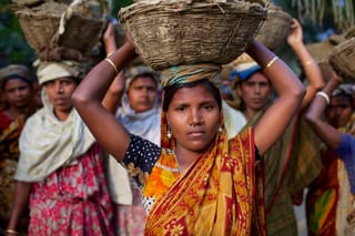 Woman carrying basket traditional dress village