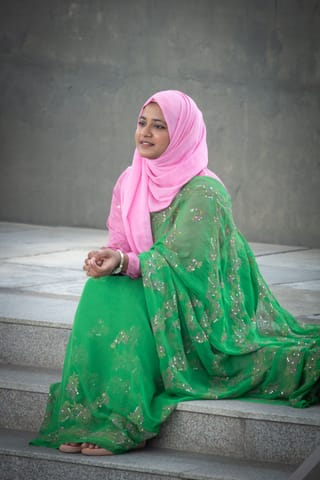 Woman green traditional dress pink hijab portrait