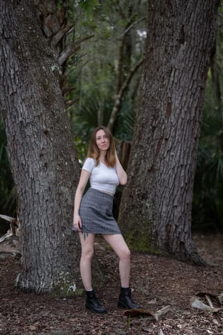 Woman grey dress large tree forest portrait