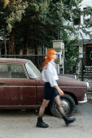 Woman walking vintage car street photography