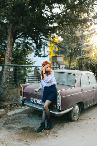 Redhead woman classic car outdoor portrait