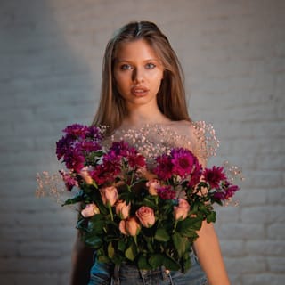 Woman floral dress holding flower bouquet
