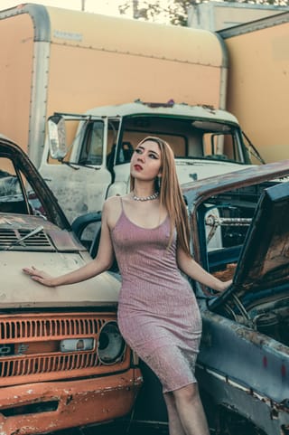 Woman pink dress vintage truck fashion portrait