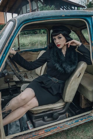Woman black dress vintage truck cab portrait