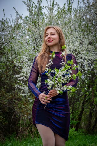Woman black dress wildflower bouquet portrait