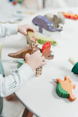 Children playing with toys in a creative activity.
