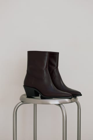 Brown ankle boots in a minimal fashion setting.