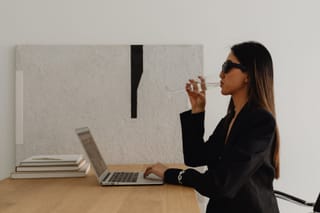 Businesswoman working on a laptop in a modern office.