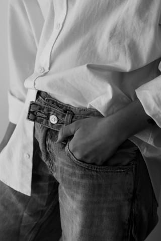 Casual white shirt and blue jeans fashion detail.