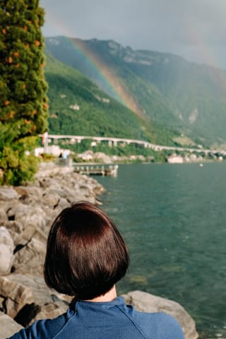 Woman looking across a scenic mountain lake.