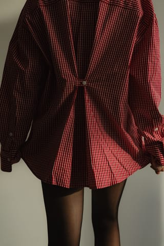 Woman in a red blazer with black tights.