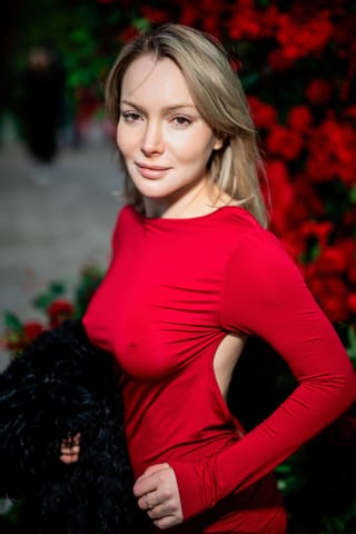 Woman in a red sweater in an outdoor portrait.