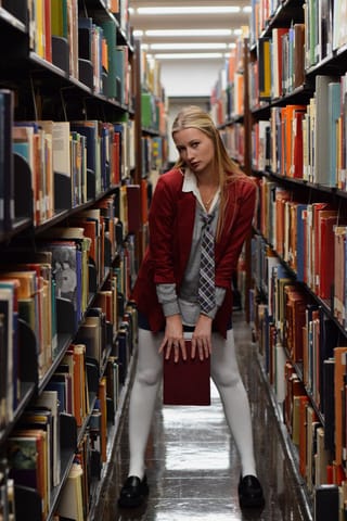 Blonde student library bookshelves campus lifestyle.