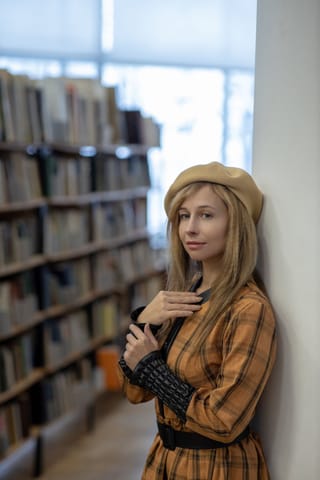 Blonde woman library plaid jacket portrait.