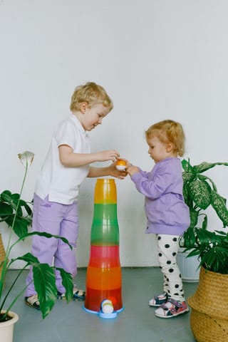 Children stacking colorful toys indoor play.
