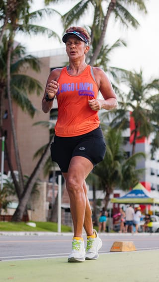Female runner tropical road fitness training.