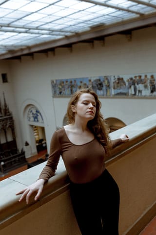 Pregnant woman museum gallery lifestyle portrait.