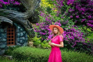 Woman pink dress flower garden cottage.