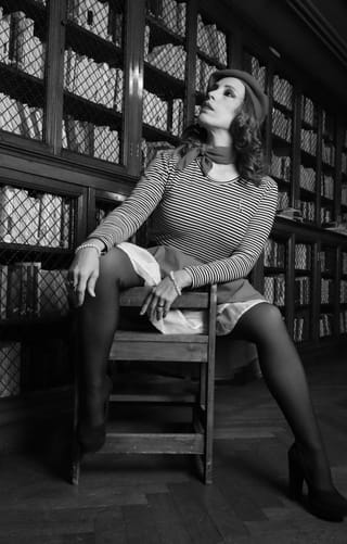 Woman polka-dot dress black tights vintage portrait.