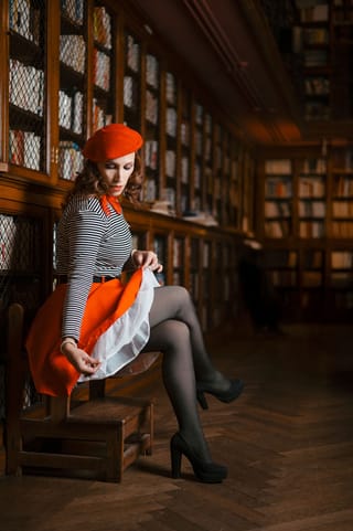 Woman red beret library skirt black tights fashion.