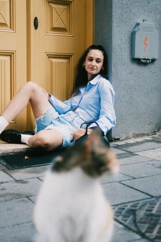 Woman sitting outside home cat pet lifestyle.