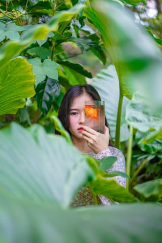 Woman taking photo tropical garden smartphone.